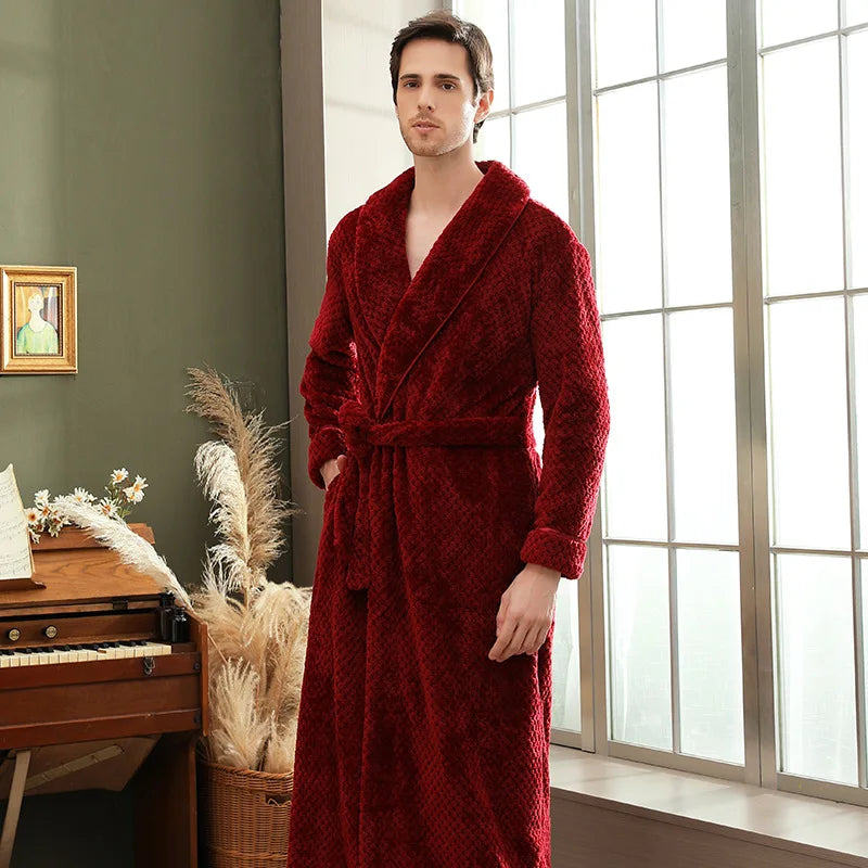 Man wearing a red robe standing in a room with a piano and window.